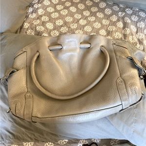 Cole Haan beige hobo. Magnetic close on top and clasp closure pockets on sides